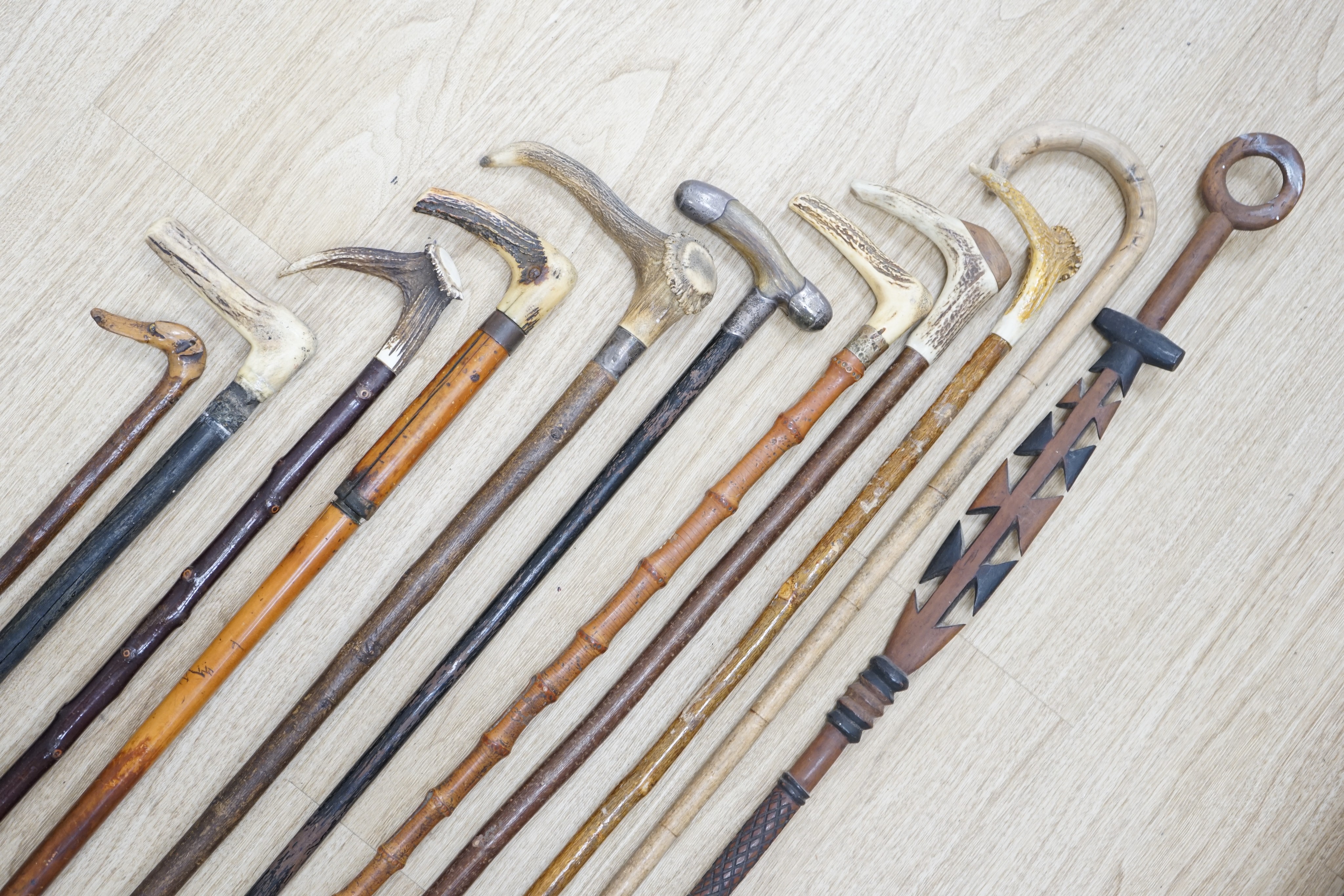Twelve assorted walking sticks including silver mounted and staghorn handled